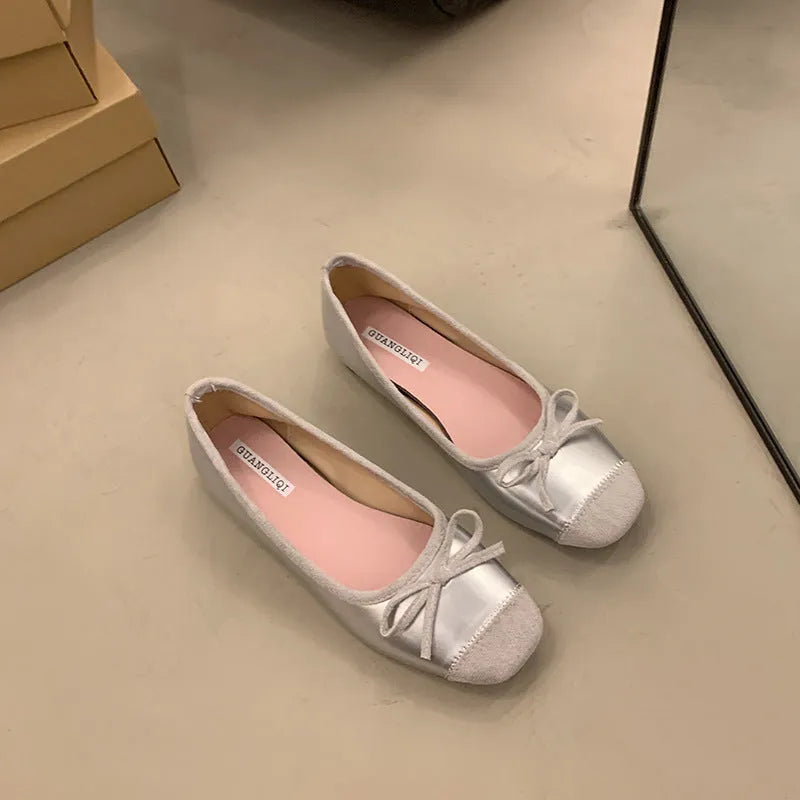 Retro apricot colour Mary Jane ballet flats with bow detail and square toe on a white background.