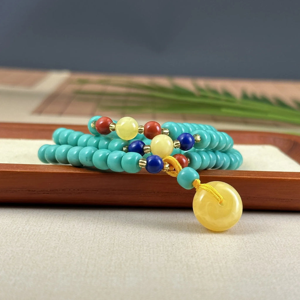 Turquoise mesh flower lucky pendant on an adjustable ball bead necklace, 71-80cm long.
