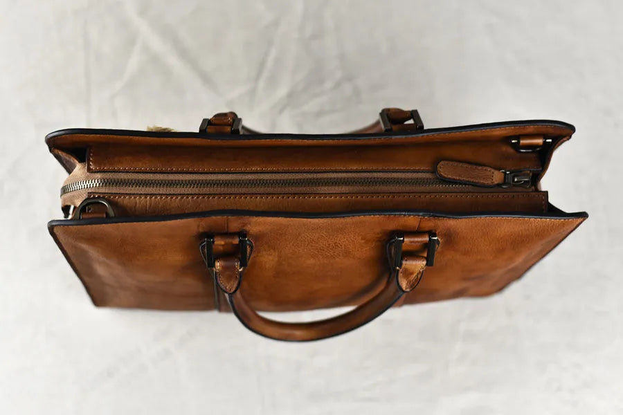 Men's brown leather business handbag with horizontal square shape and zipper closure