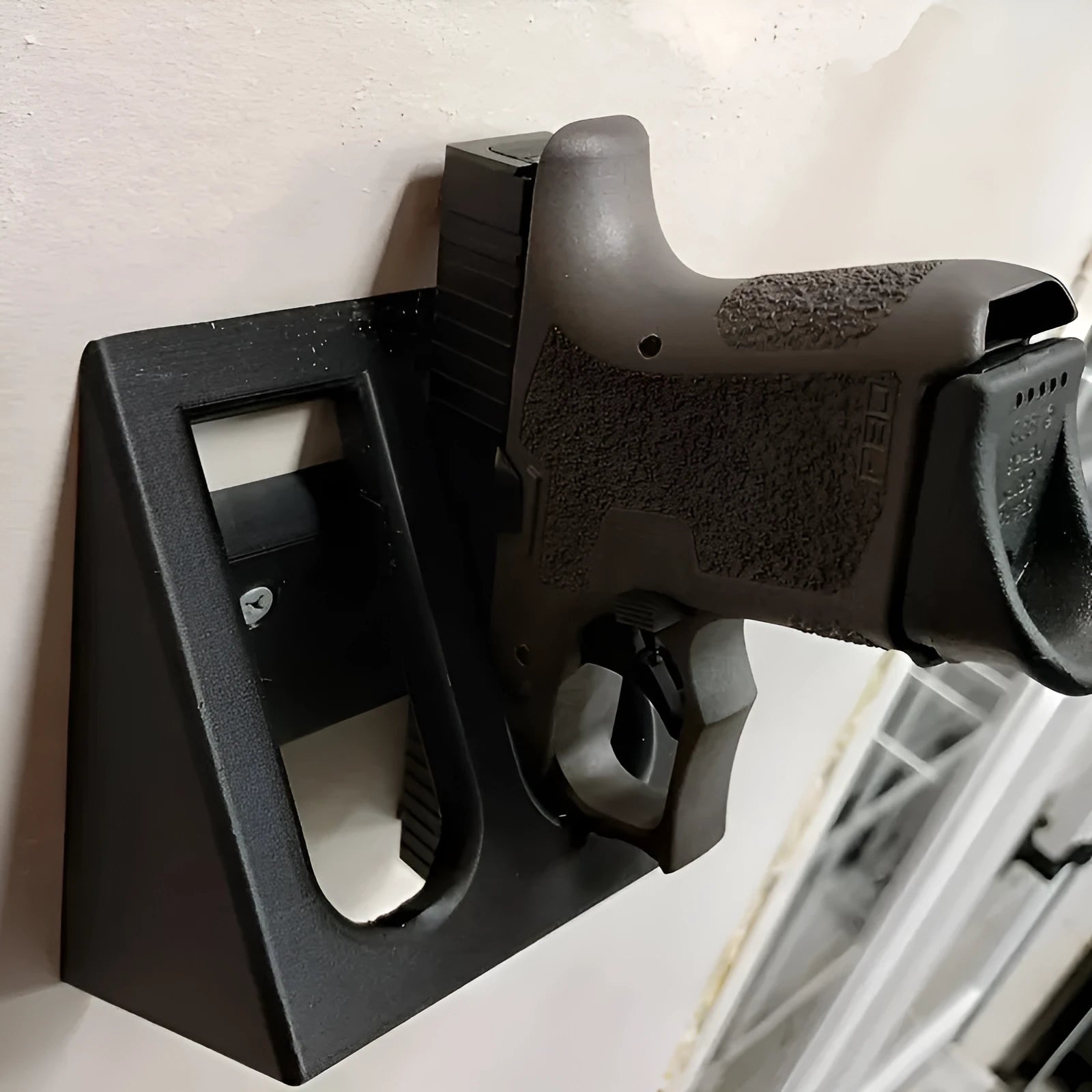 Black punk-style plastic pistol display stand for toy guns and model firearms.