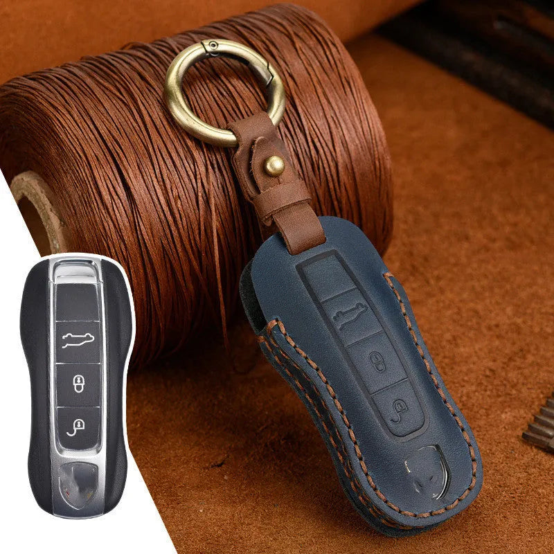 Brown leather Porsche key case with a metal buckle closure.