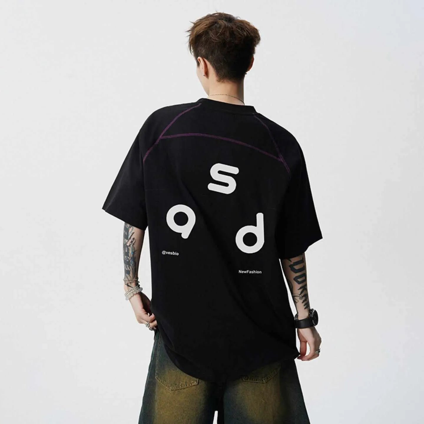 Man's loose fit black cotton T-shirt with large white letter print on the front.