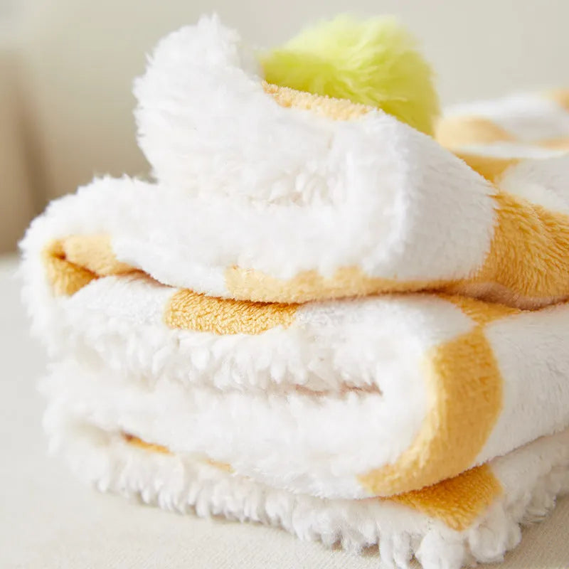 Plush fleece pet blanket with plaid pattern and fur ball decoration for cats and dogs