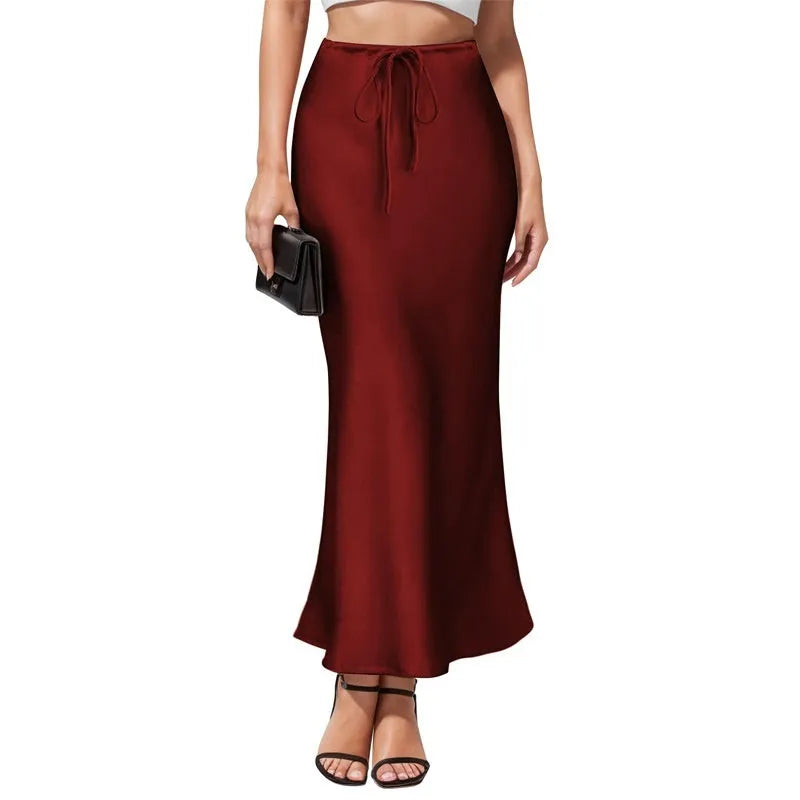 Women's high-waisted asymmetric acetate satin skirt in a solid colour with an irregular hemline.
