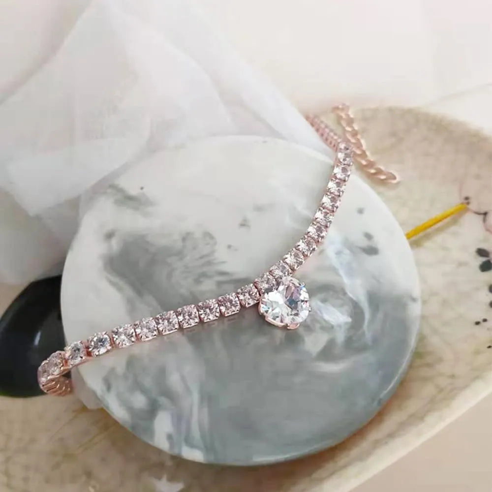 Gold rhinestone heart-shaped decorative collar for a dog or cat on a white background.