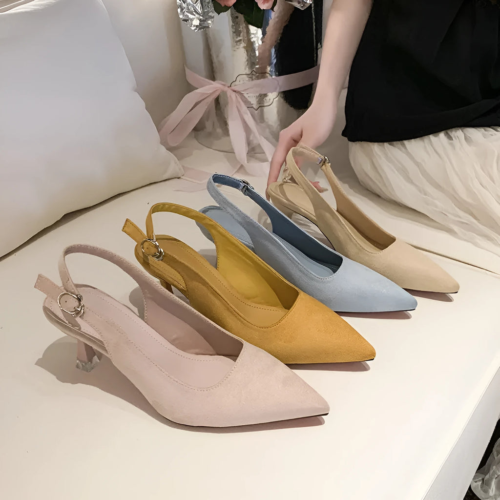 Women's pink suede pointed-toe stiletto high heels on a plain background