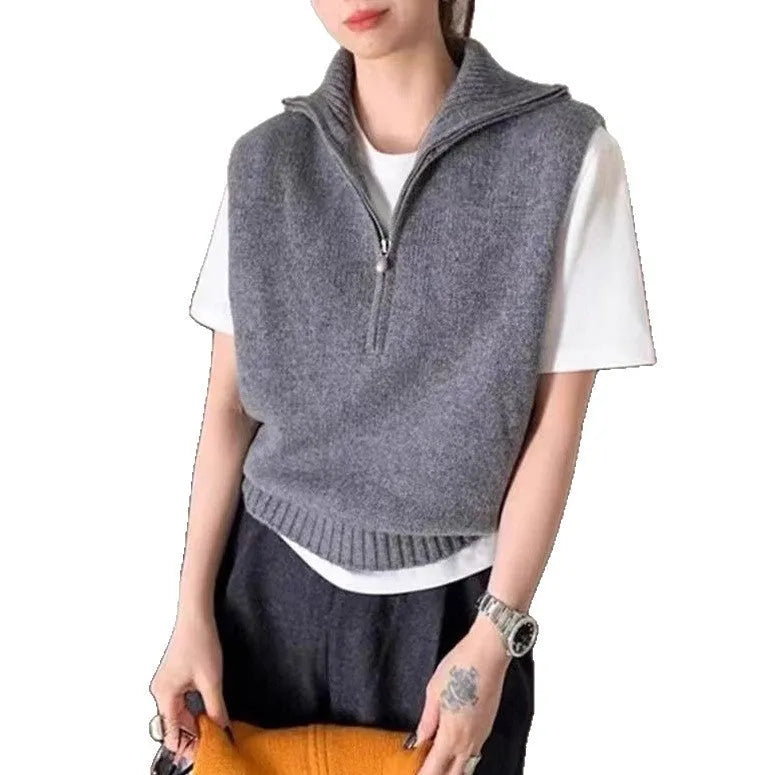Woman's sleeveless half-zip knit vest with a 3D textured pattern in a solid colour.