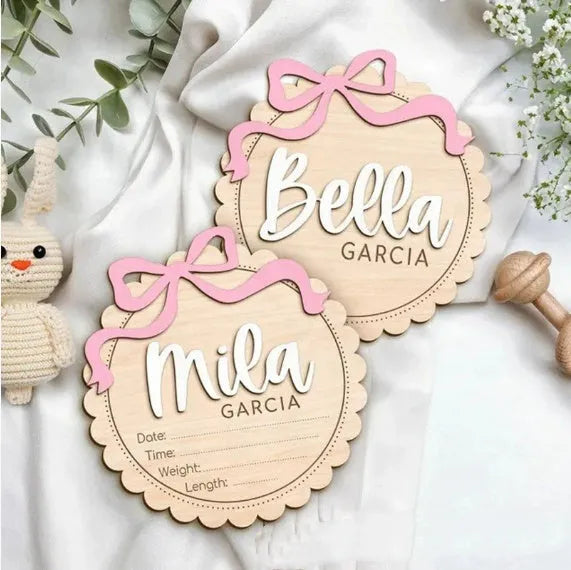 Customisable square wooden baby room ornament with a name, shown in two size options.