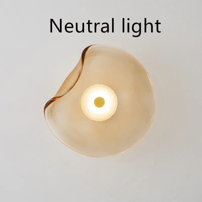 Round decorative wall lamp with glass shade in choice of cognac, light purple, or smoky grey finishes for bedroom lighting