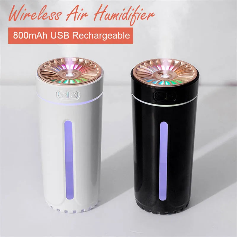 Compact black wireless humidifier with colourful LED lights sitting in car cup holder