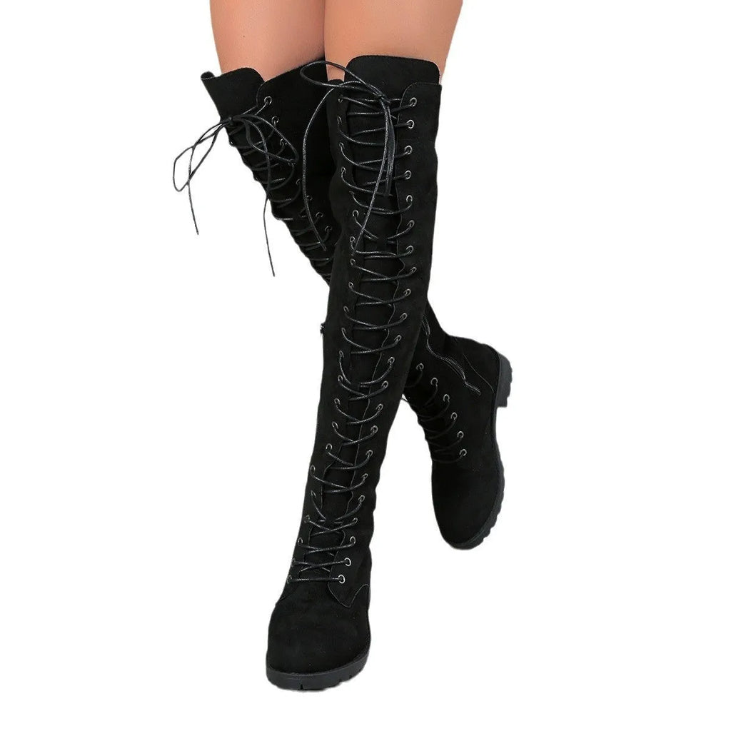 Black lace-up over the knee flat heel boots with stitching details on a round toe.