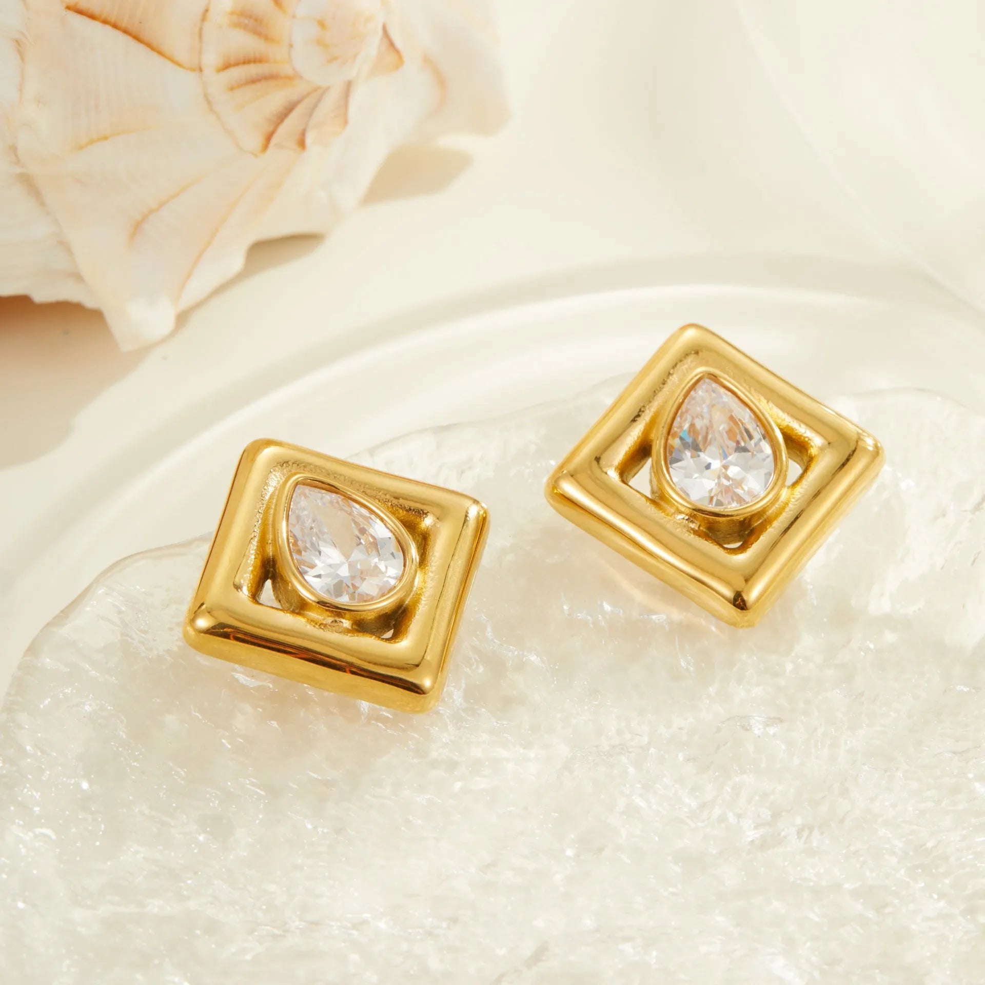 Gold geometric stud earrings with water drop zircon inlaid detail on stainless steel