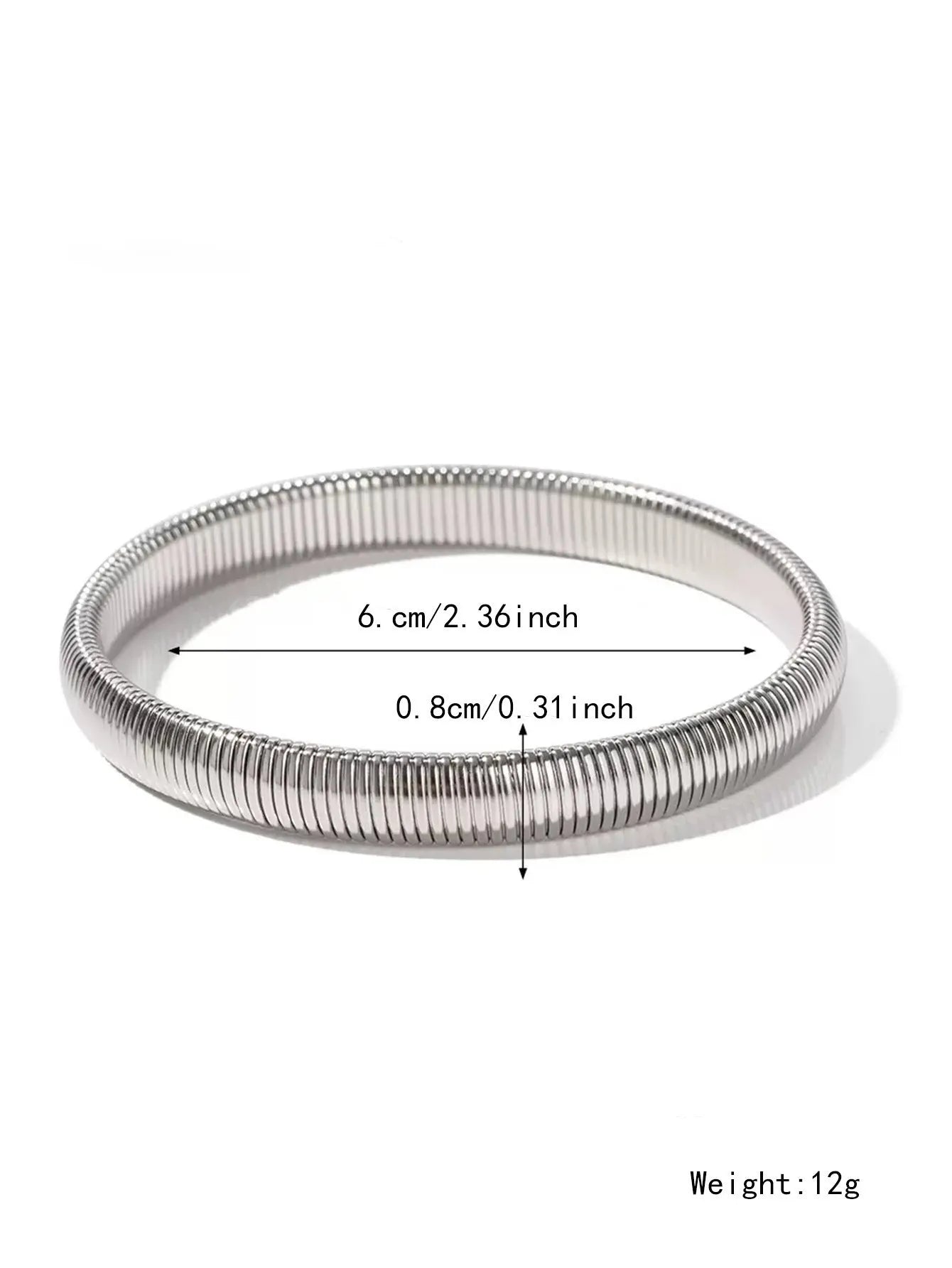 Gold titanium steel bracelet with wide vertical stripe ring pattern and elastic band on a wrist.