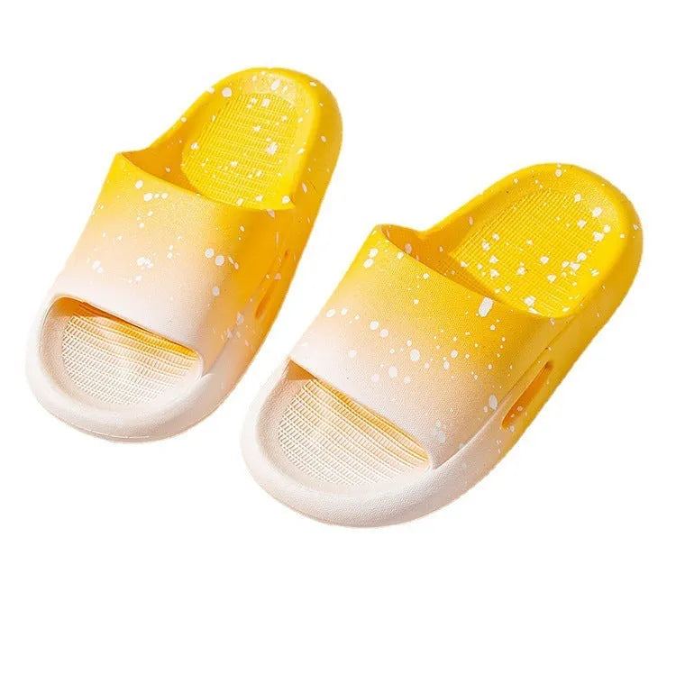Gradient blue children's PVC summer slippers with a non-slip sole on a wooden deck.