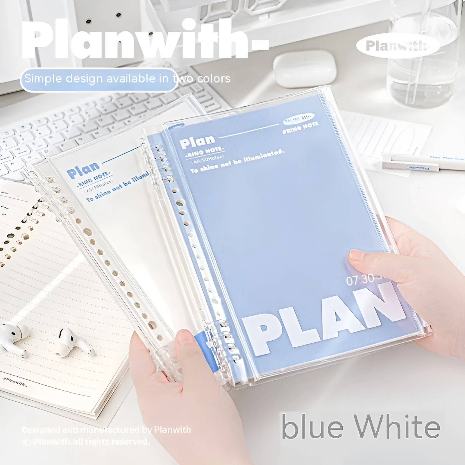 A5 spiral notebook with transparent PVC cover in blue, showing loose pages inside, next to a white version.