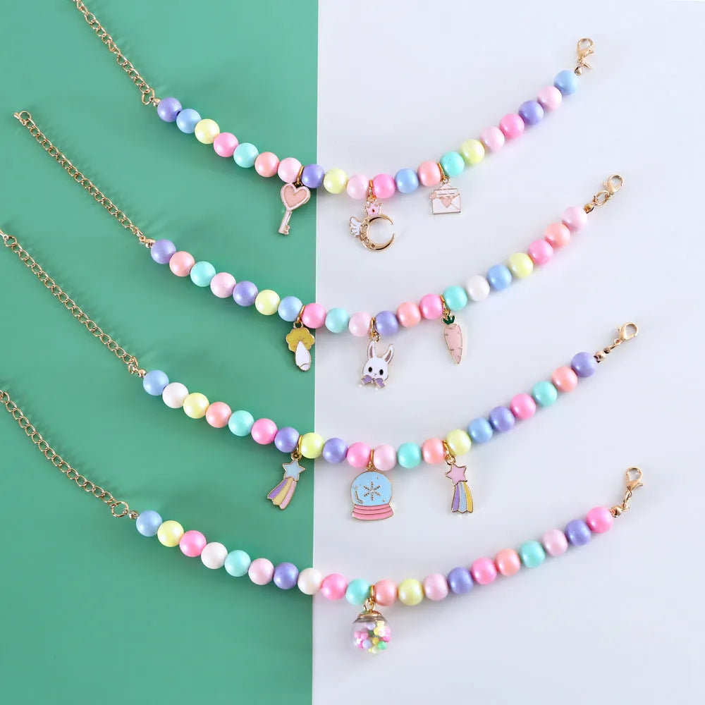 Pet wearing a resin headdress, collar, necklace, and bracelet set in a macaron colour with moon and star designs.