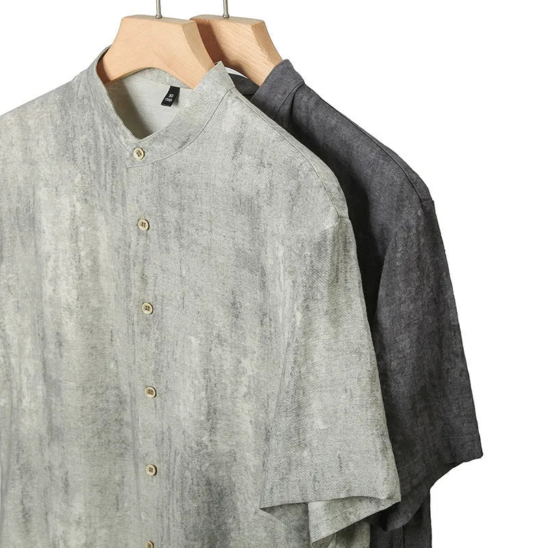 Men's loose grey linen shirt with stand collar, cardigan style, on a hanger.