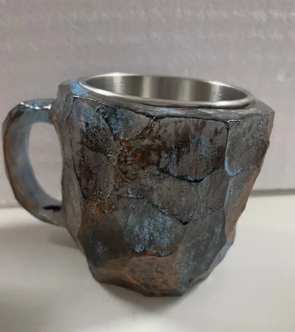 Purple and blue resin coffee mug with crystal texture and handle on wooden table
