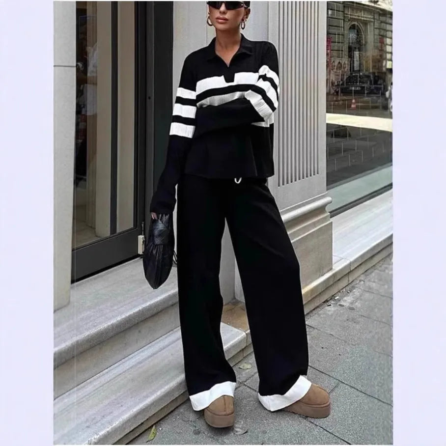 Women's black and white striped knitted polo shirt and trouser two-piece set.