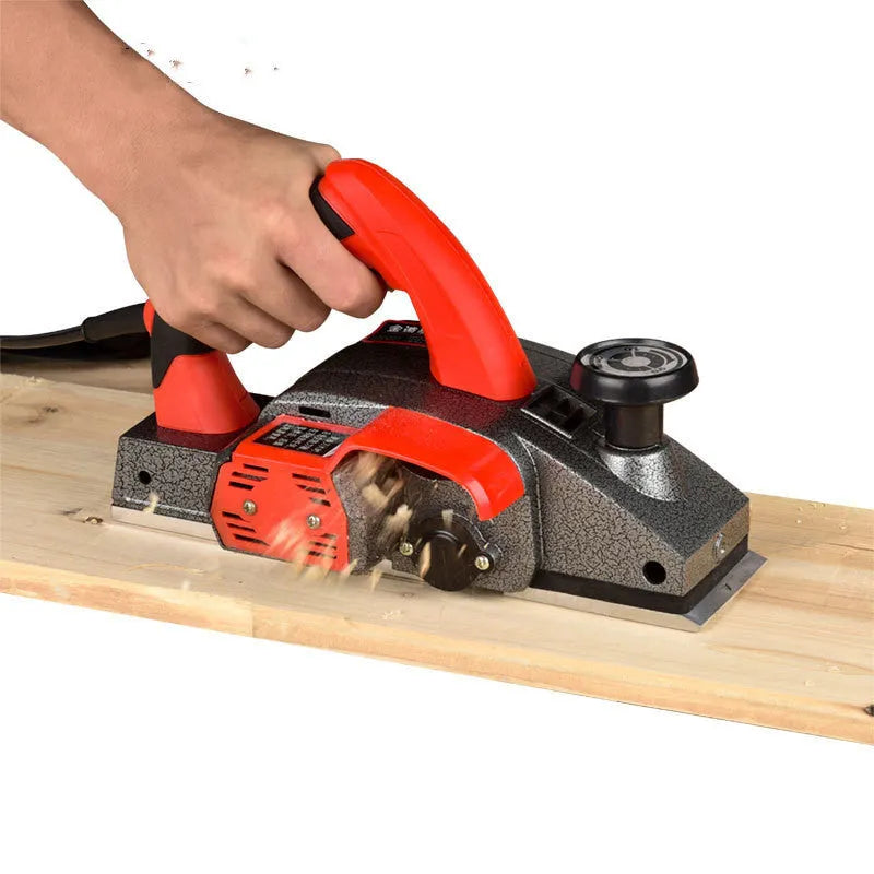 Red desktop electric wood planer with 82mm cutting width and aluminium housing