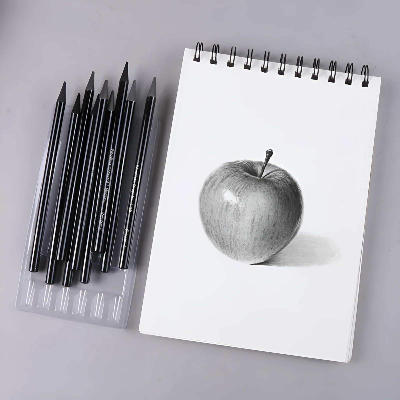 Set of nine wooden drawing pencils with six graphite and three carbonized pencils on suction card packaging