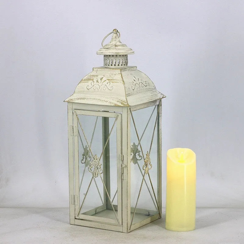 Black and white wrought iron floor-standing storm lantern with tempered glass panes for garden decoration.