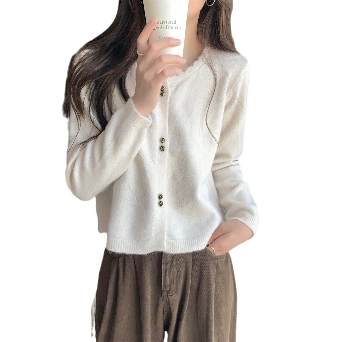 Women's long-sleeved acrylic sweater cardigan coat in milky white, shown as a layering piece.