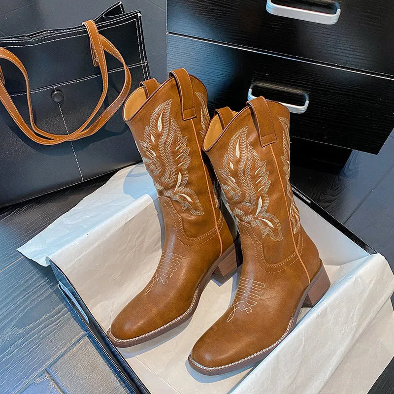 Brown women's embroidered Martin boots with a mid-calf height and low square heel.