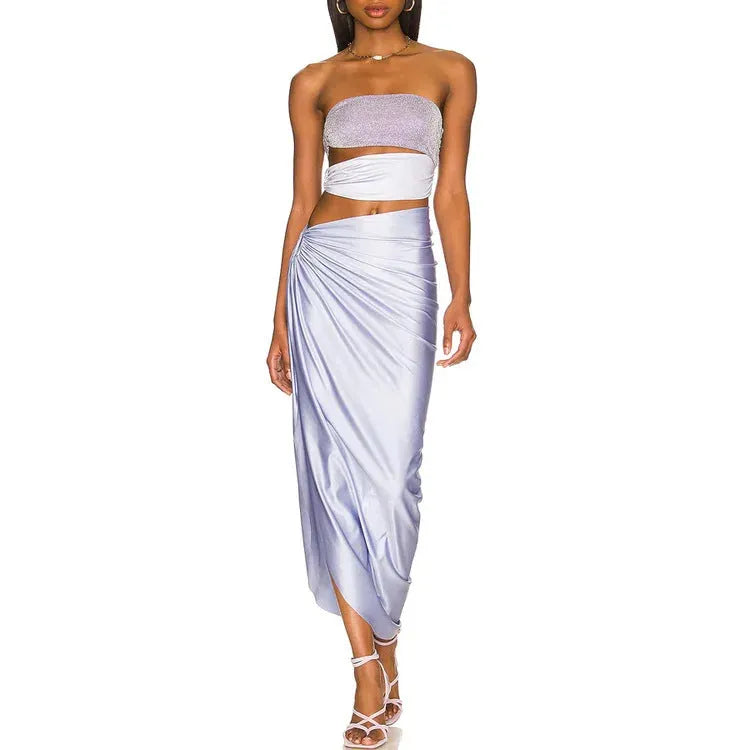 Purple hollow one-piece swimsuit with matching wrap skirt on a model.