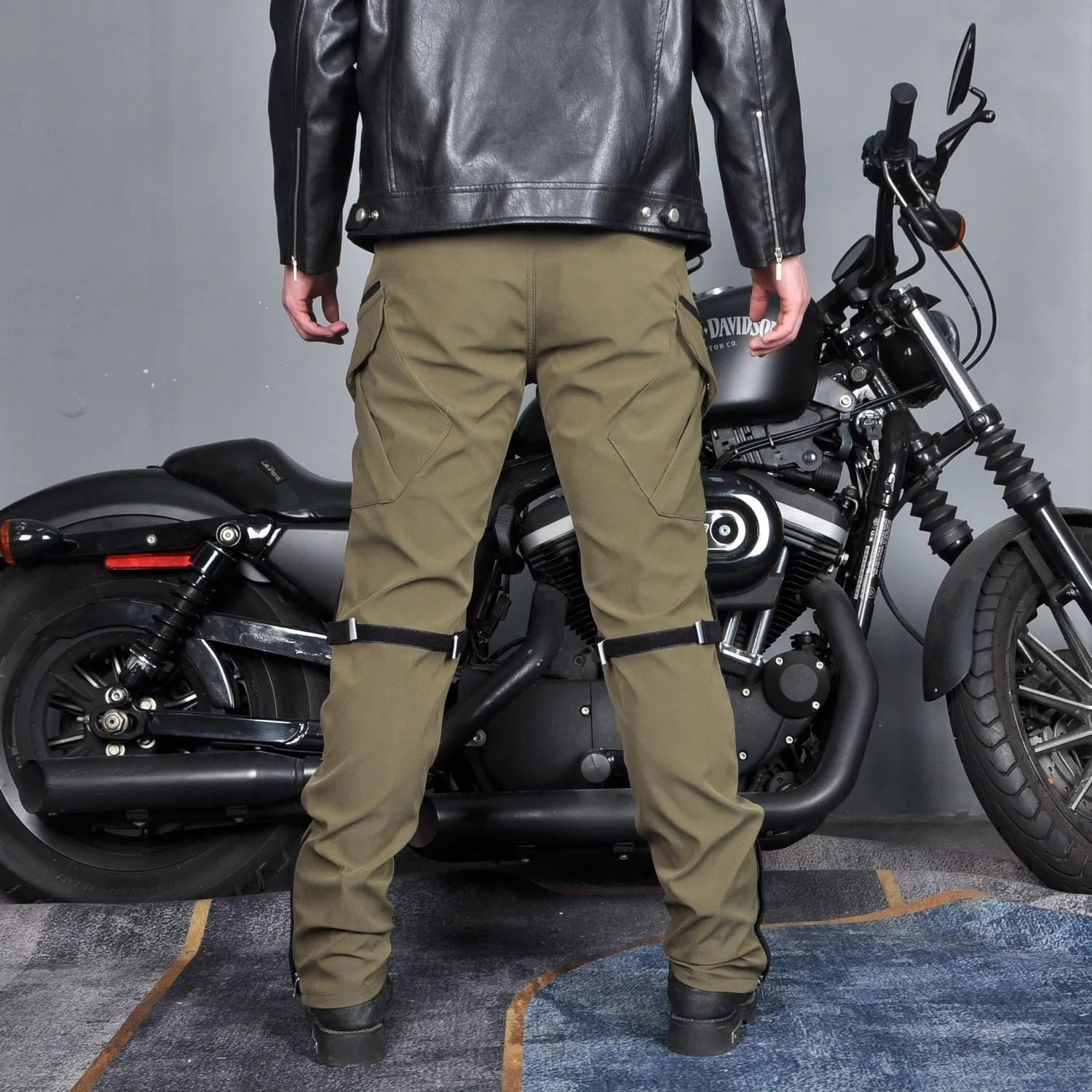 Men's waterproof motorcycle trousers in green and black colours with belt and protective gear