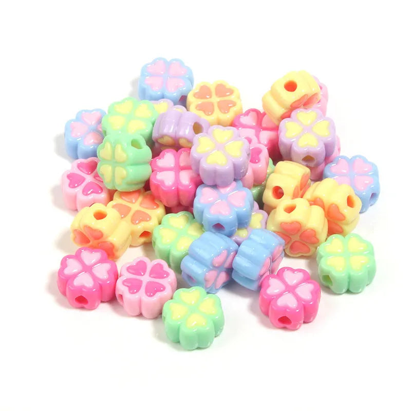 Mixed colour frosted acrylic four-leaf clover shaped beads, each 15mm in size.