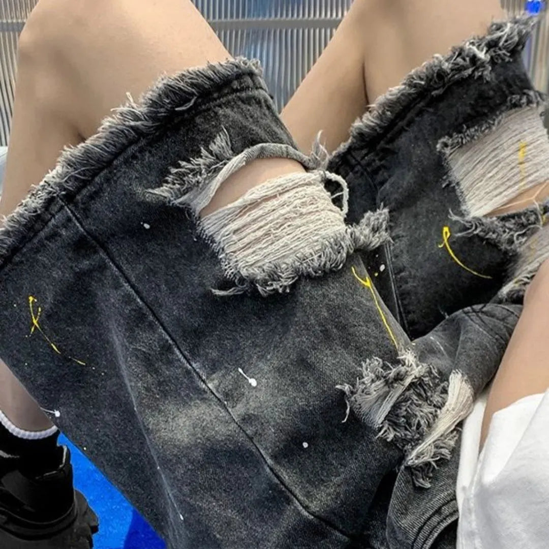 Men's loose fit water washed light blue denim shorts with hole details on a mannequin.