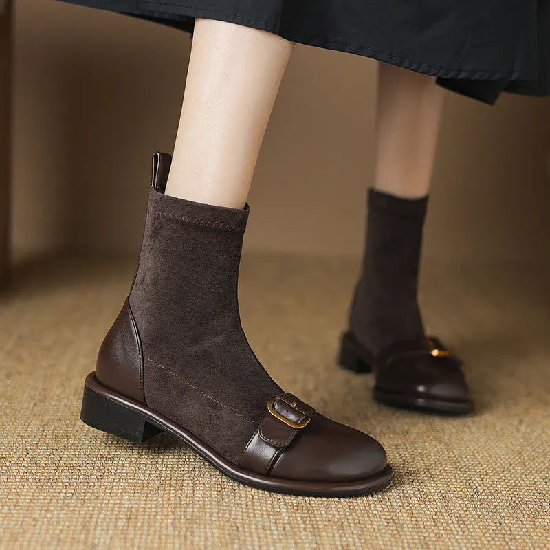 Women's black low-heel Martin boots with lace-up front and decorative belt buckle stitching.