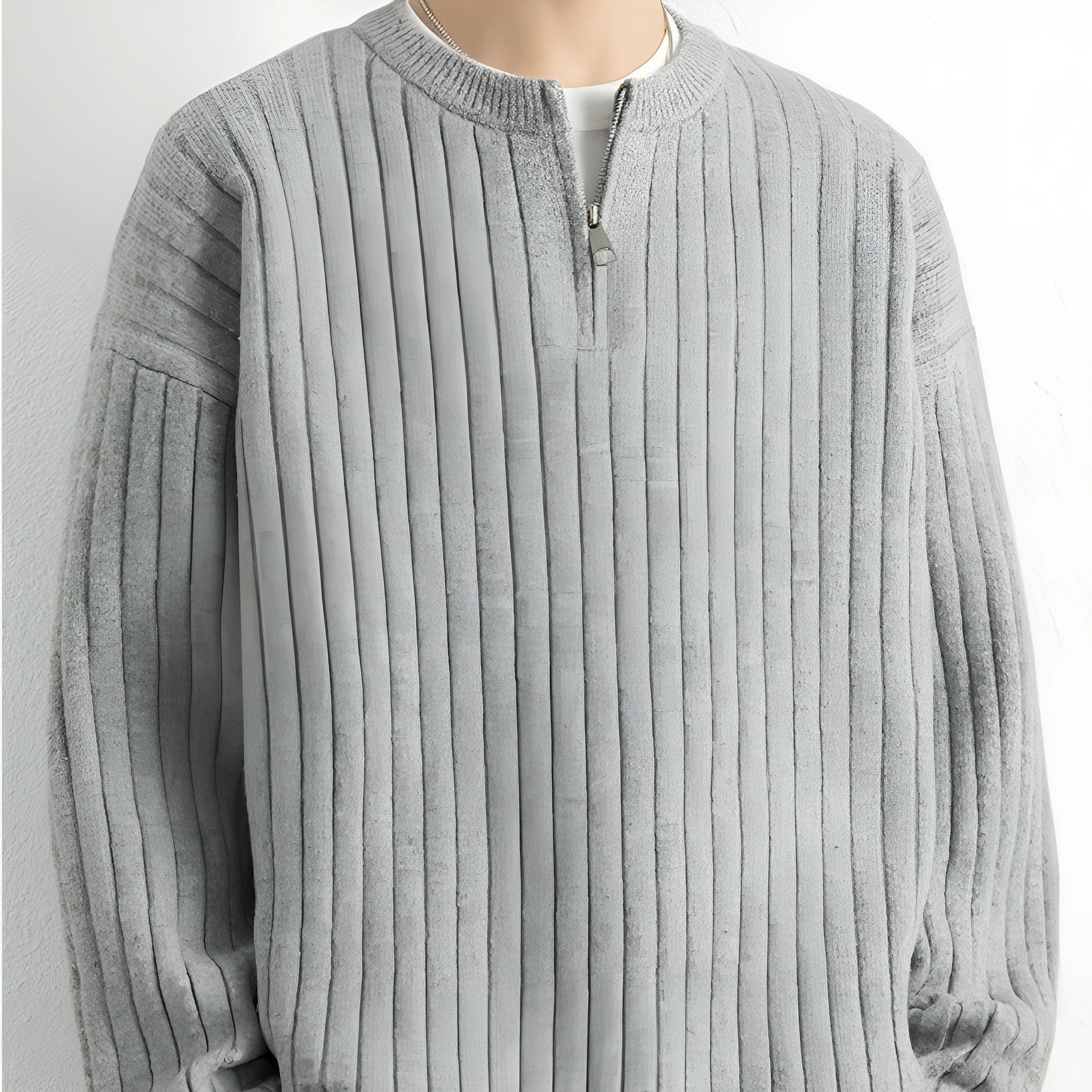 Men's grey half-zip loose knitted pullover sweater with textured fabric on a solid colour background.