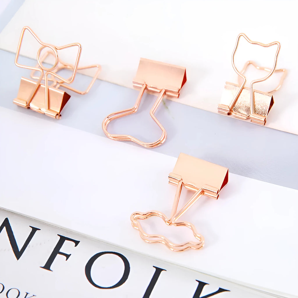 Small gold-plated decorative metal clip with long-tail design, showing optional flamingo, love, clouds, cat, cactus, and bow motifs.