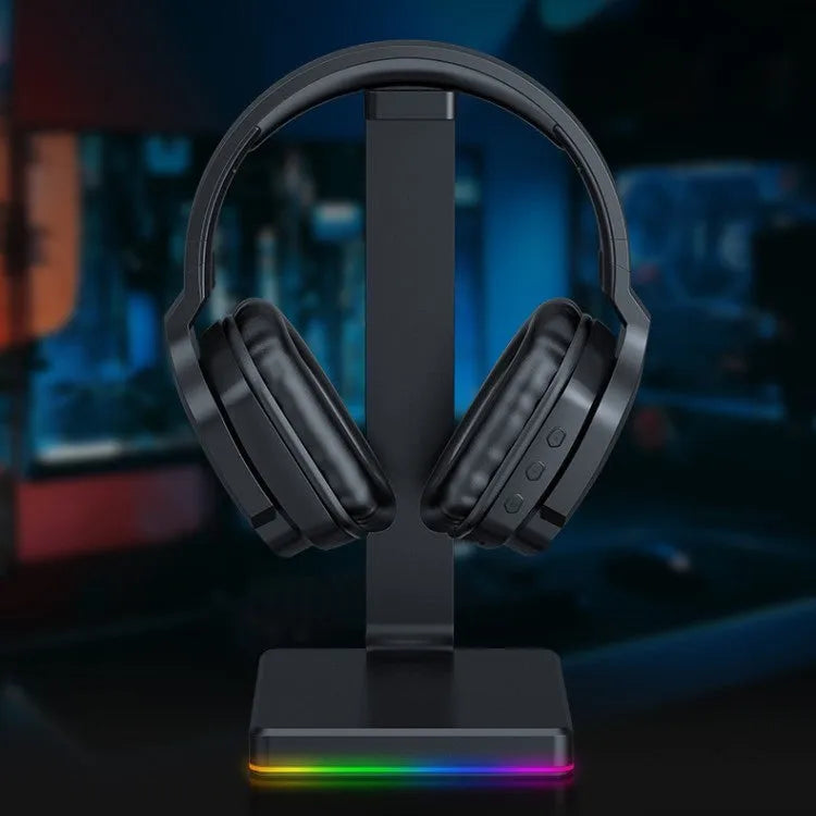 Luminous black wireless over-ear gaming headphones with adjustable headband showing ear cups and included 3.5mm cable