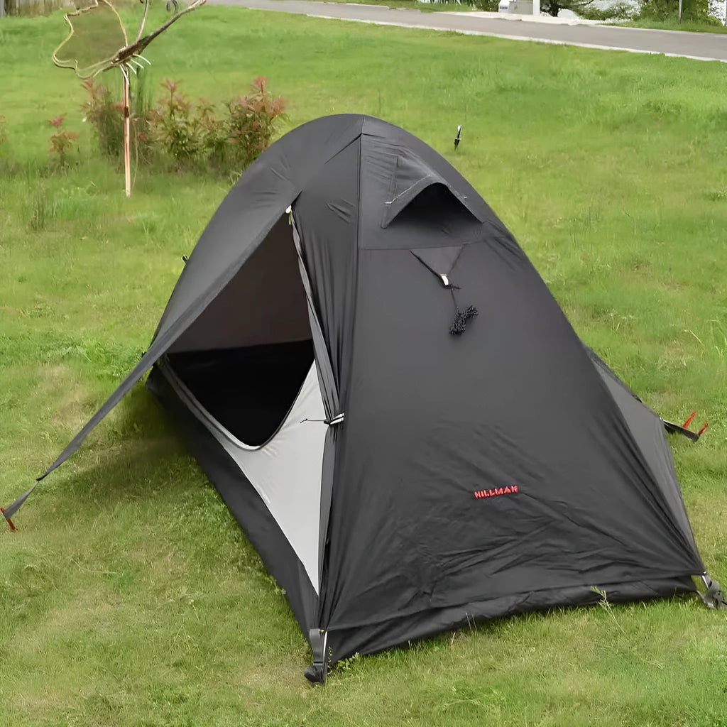Single person red tent with aluminium poles, shown pitched in a forest