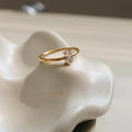 Gold electroplated stainless steel women's ring with heart design in oval shape on finger