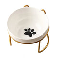White ceramic cat bowl with decorative footprints in black iron frame with cat ear detailing