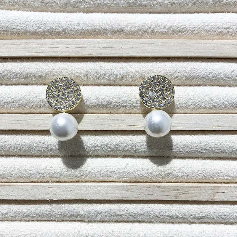 Round diamond studded pearl earrings in gold finish with secure stud fastening