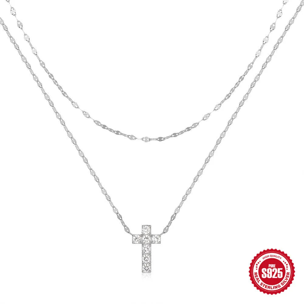 S925 sterling silver double layer twin diamond cross pendant on a clavicle chain, shown in gold and white gold finishes.