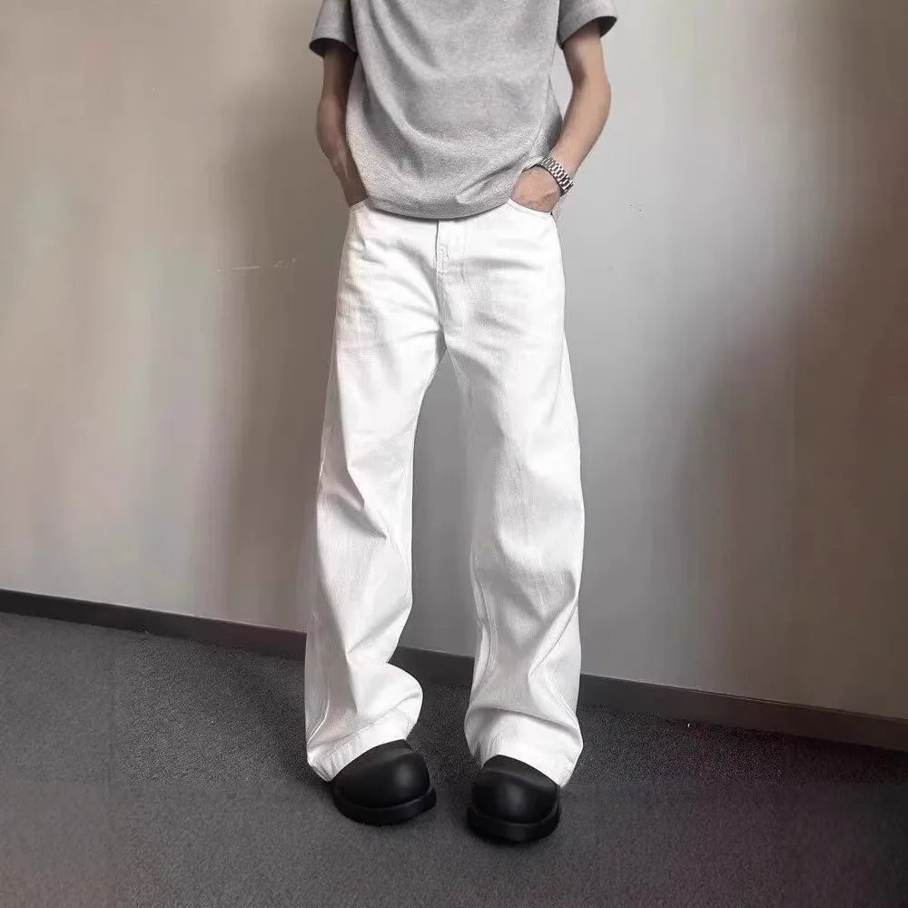 Men's white straight-leg cotton denim jeans on a hanger, showing front view with zipper fly.