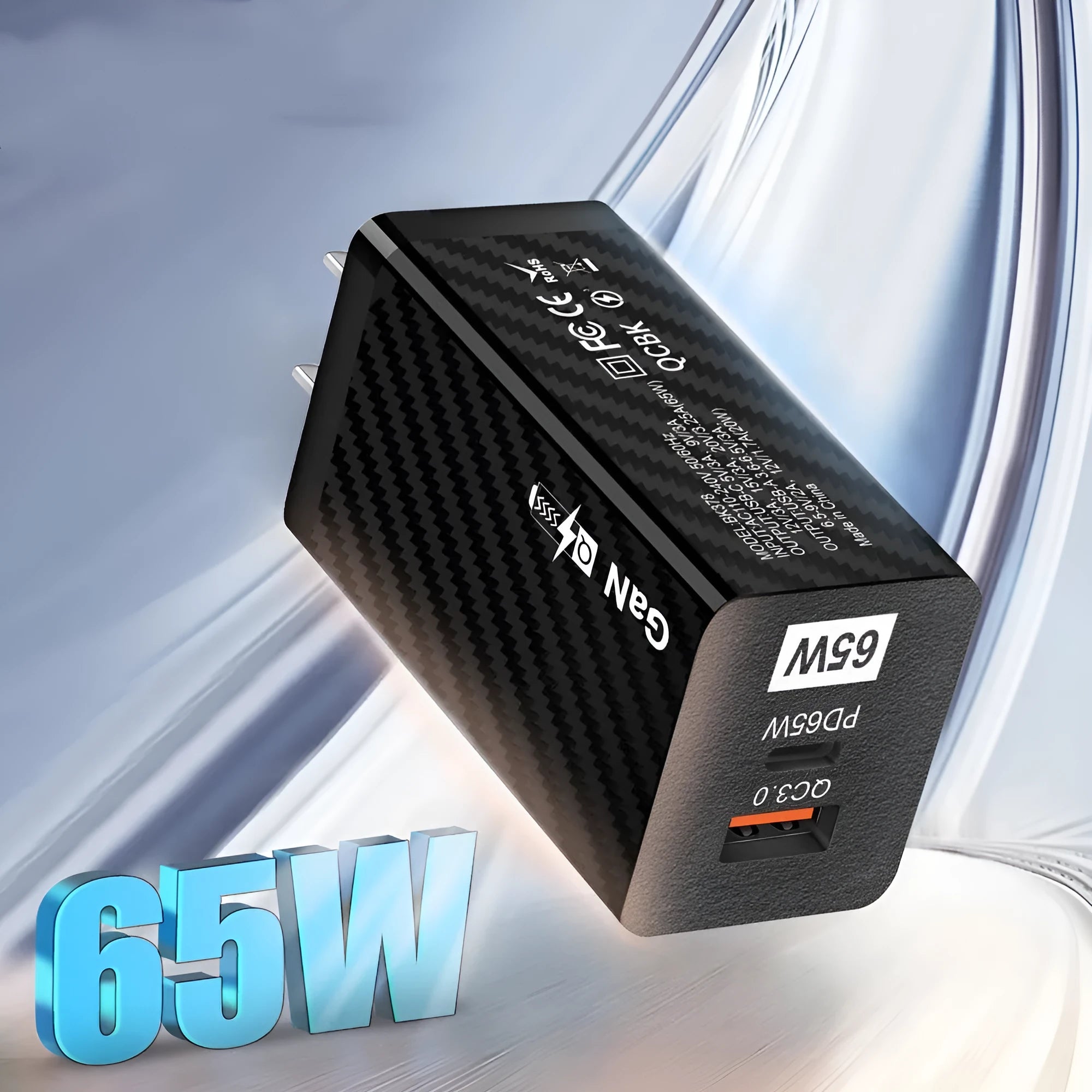 Compact white GaN 65W USB-C laptop charger with EU, UK, and US plug attachments on a table.