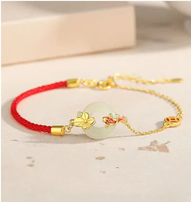 Women's 925 silver bracelet with gold electroplated peace buckle, koi fish charm, and adjustable red rope.