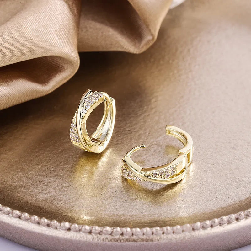 A pair of geometric-shaped copper earrings with a zircon-treated 14K yellow finish.