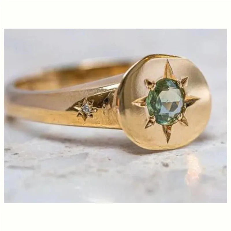 Gold-colour adjustable ring with a star-shaped design and oval asterism zircon.