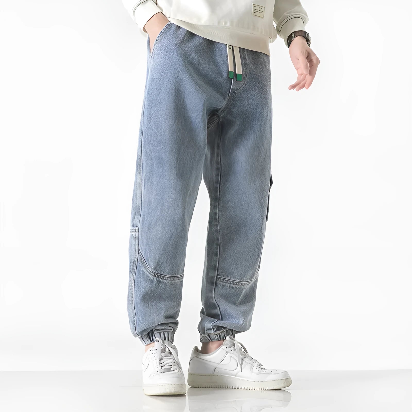 Men's loose-fit tapered trousers in cotton fabric, available in black, blue, and grey colours