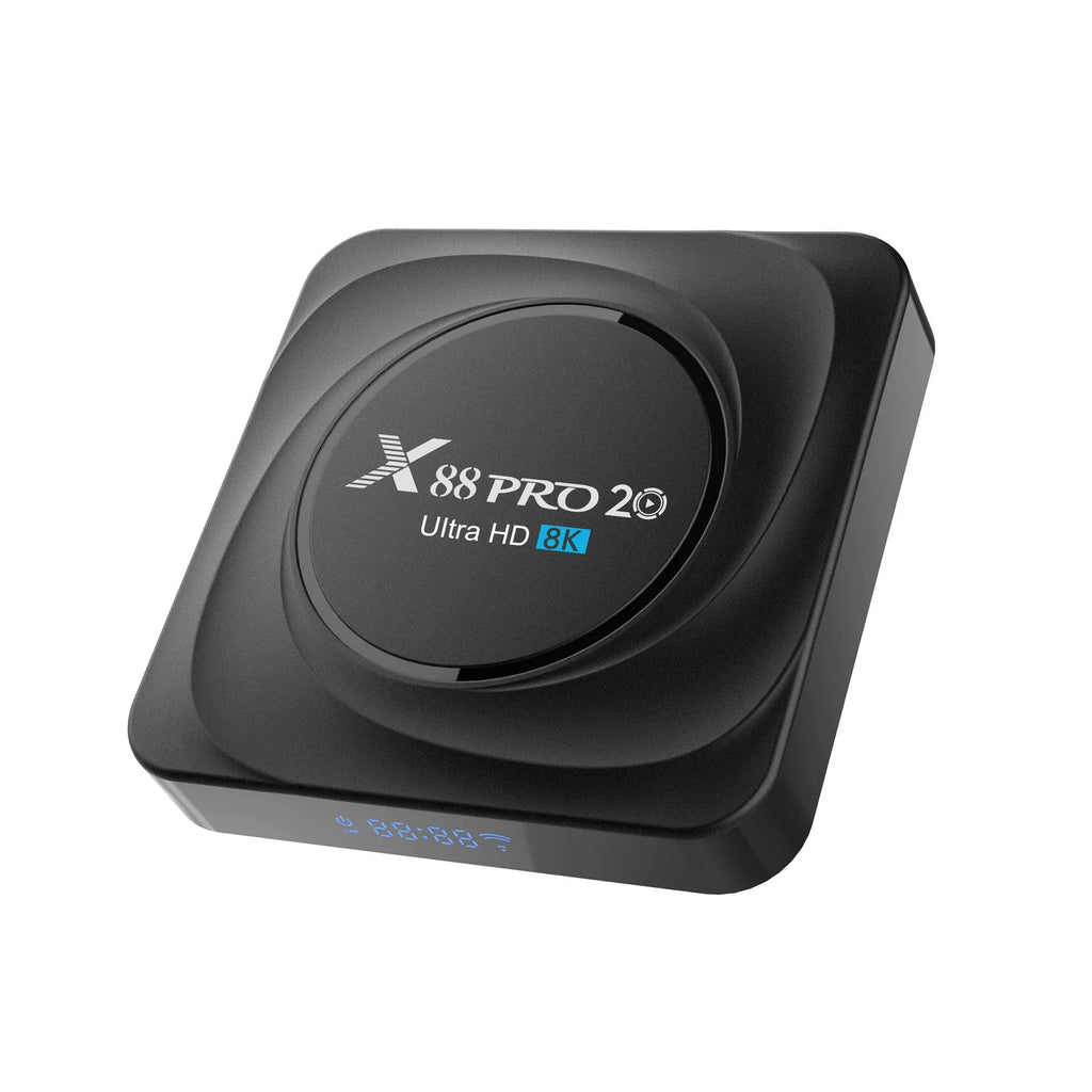 Compact black Android TV set-top box with remote control and HDMI cable on a wooden surface.