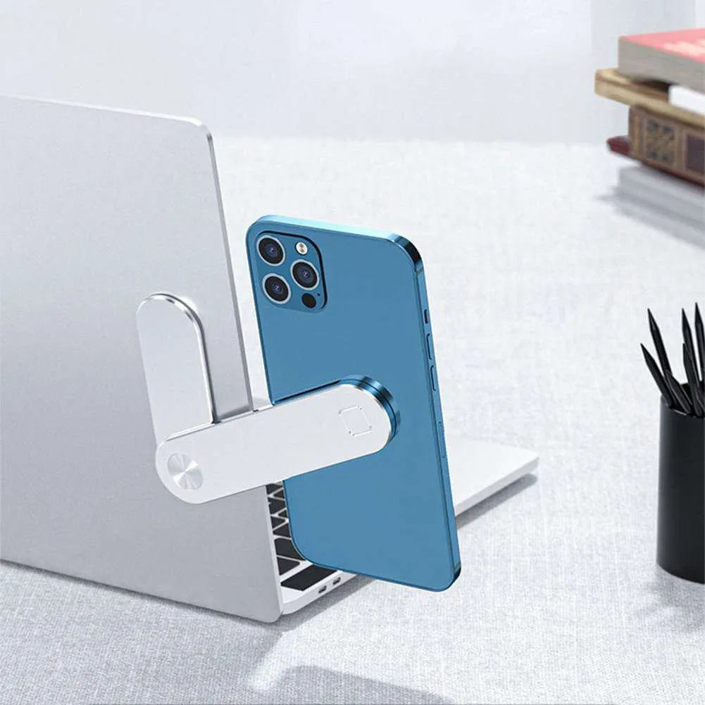 Black aluminium laptop phone holder with magnetic clip attached to a laptop screen, holding a smartphone.