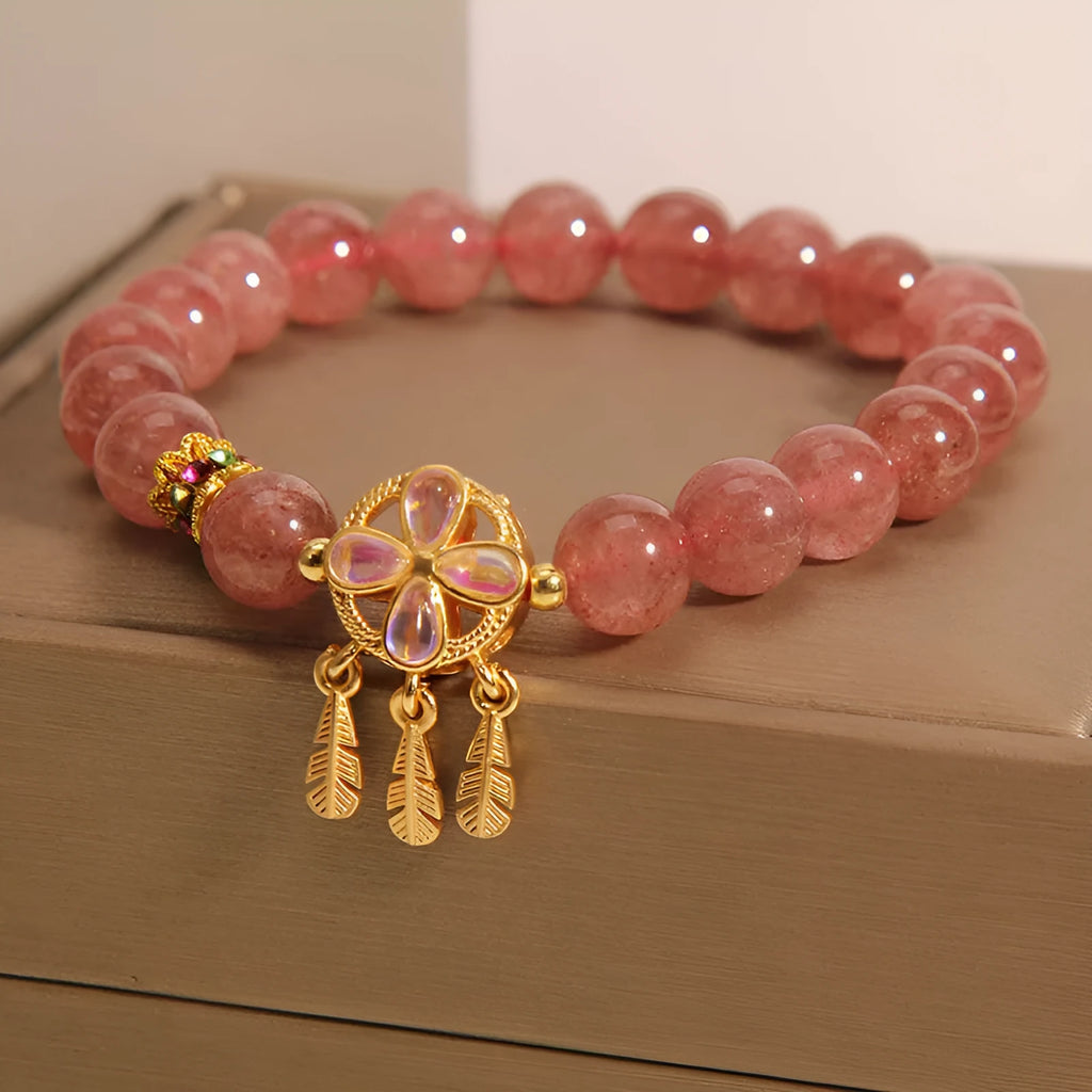 Women's strawberry quartz bracelet with four-leaf dream catcher ball pendant, original crystal jewellery design